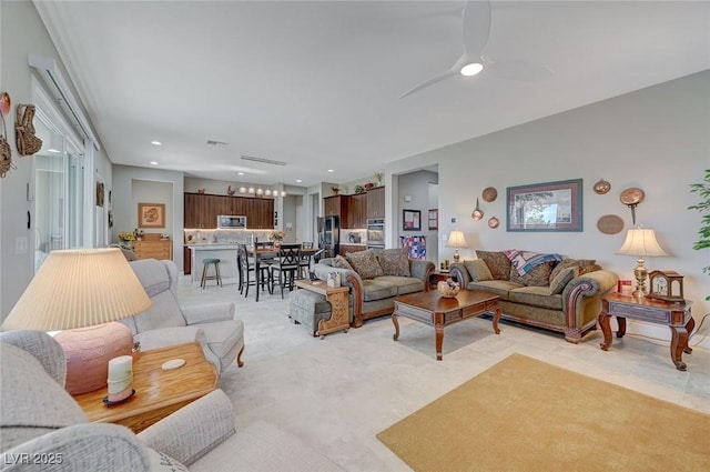 living room with ceiling fan and light tile patterned flooring