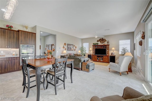 tiled dining space featuring ceiling fan