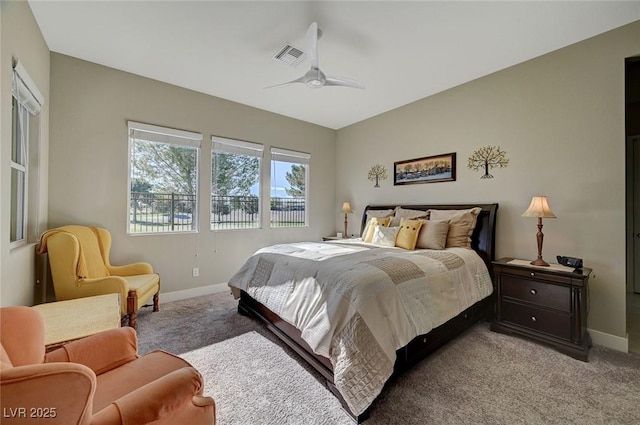 bedroom with ceiling fan and light carpet