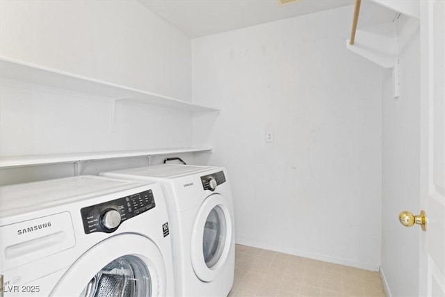 clothes washing area with washing machine and clothes dryer