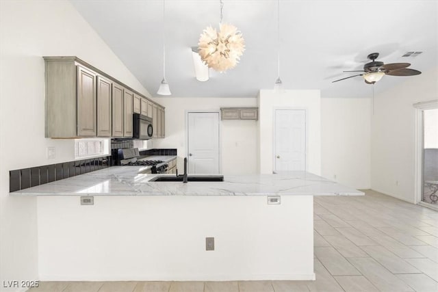 kitchen featuring kitchen peninsula, stove, light stone counters, ceiling fan, and pendant lighting