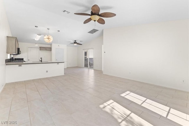 unfurnished living room with ceiling fan, light tile patterned flooring, and lofted ceiling