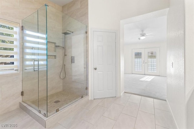 bathroom featuring tile patterned floors, ceiling fan, french doors, and a shower with door