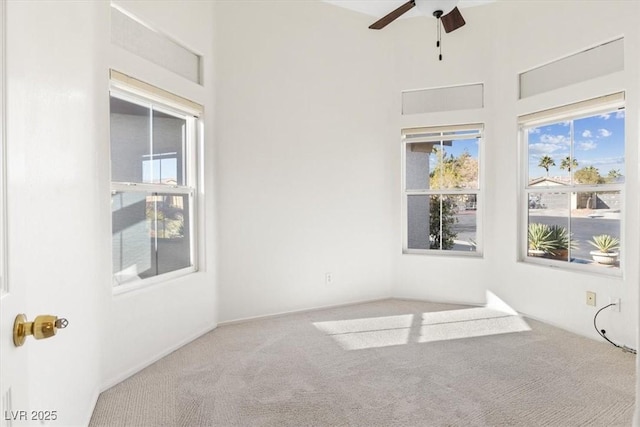 carpeted spare room with ceiling fan and a healthy amount of sunlight