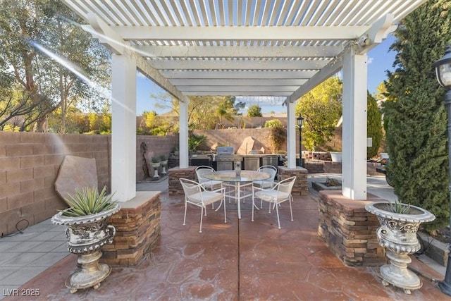 view of patio with a pergola, area for grilling, and exterior kitchen