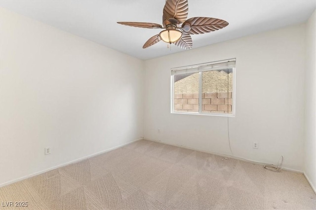 empty room featuring light carpet and ceiling fan