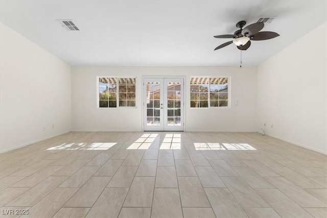 unfurnished room with ceiling fan, french doors, and light tile patterned floors