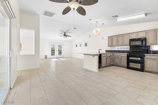 kitchen featuring kitchen peninsula, french doors, sink, black appliances, and lofted ceiling