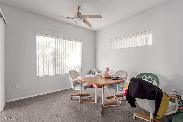 carpeted dining space featuring ceiling fan