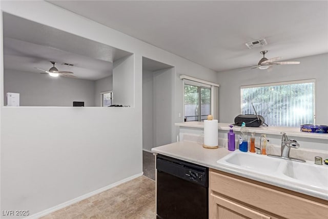 kitchen featuring sink, light brown cabinets, and black dishwasher