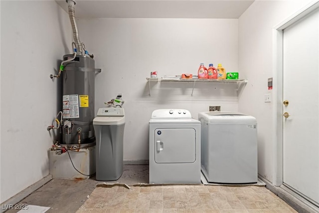 washroom with washer and clothes dryer and strapped water heater