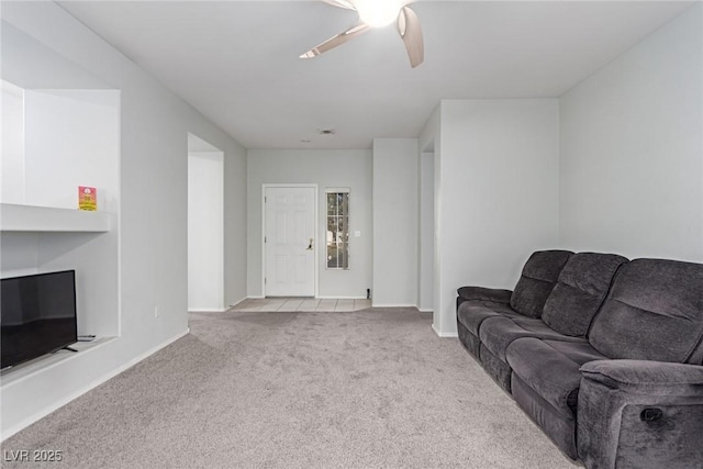 carpeted living room with ceiling fan