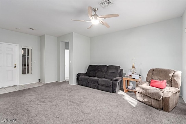 carpeted living room with ceiling fan