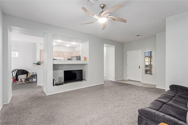 carpeted living room with ceiling fan