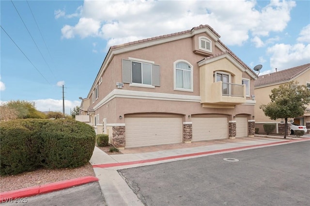 view of front of house with a garage and a balcony