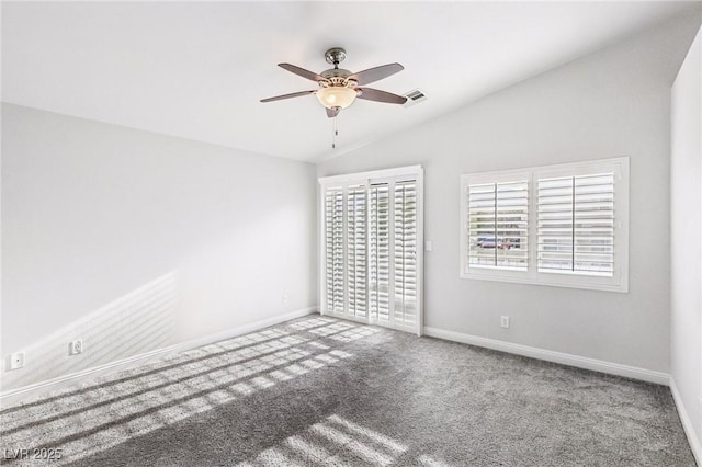 carpeted spare room featuring ceiling fan and vaulted ceiling