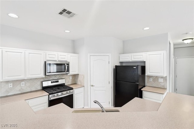 kitchen with sink, white cabinets, and appliances with stainless steel finishes