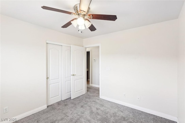 unfurnished bedroom featuring ceiling fan, a closet, and light colored carpet