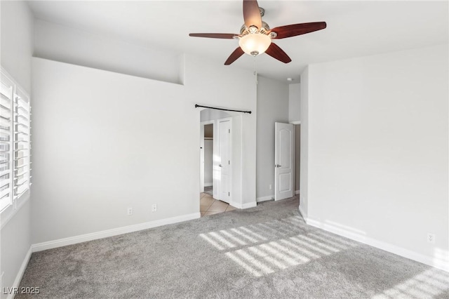 unfurnished bedroom featuring light colored carpet and ceiling fan