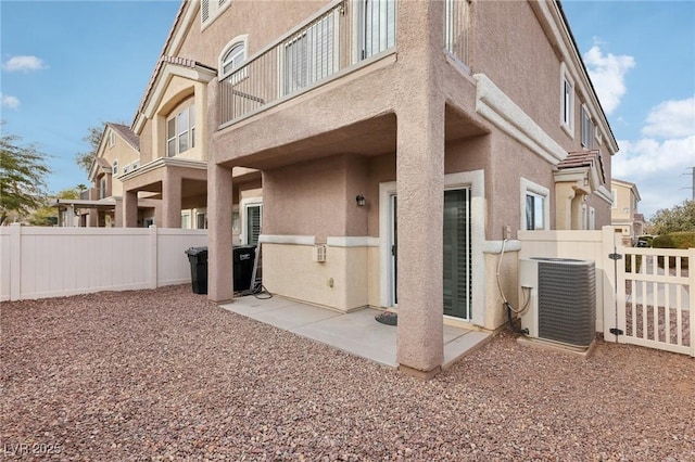 exterior space featuring a patio, a balcony, and central AC unit