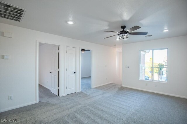 unfurnished room featuring ceiling fan and carpet