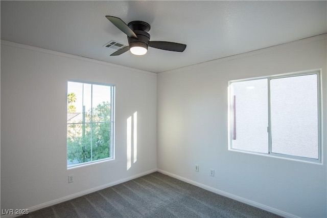 carpeted spare room featuring ceiling fan and crown molding