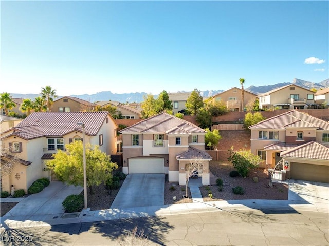 mediterranean / spanish-style home with a mountain view and a garage