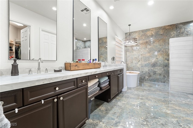 bathroom with vanity, tile walls, and independent shower and bath