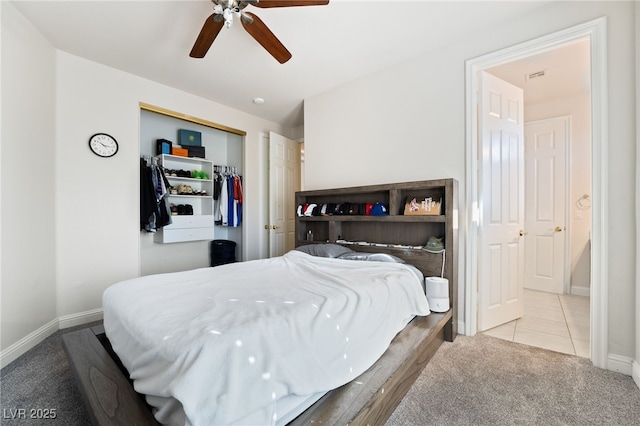 carpeted bedroom featuring ceiling fan and a closet