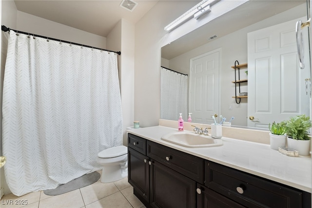 bathroom with tile patterned floors, vanity, and toilet