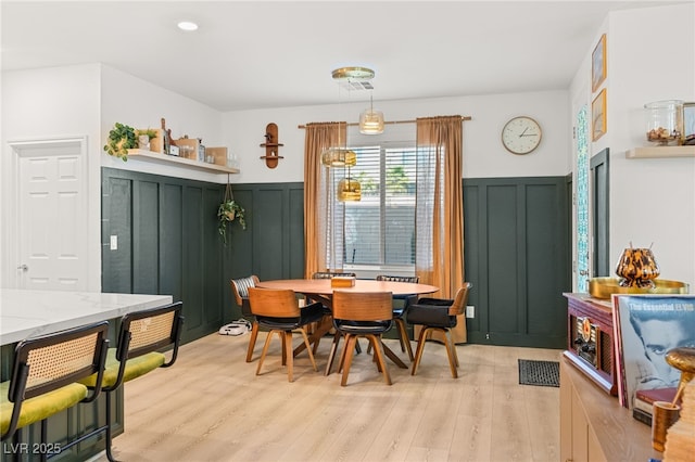 dining space featuring light wood-type flooring