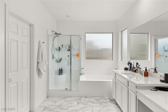 bathroom with vanity and separate shower and tub