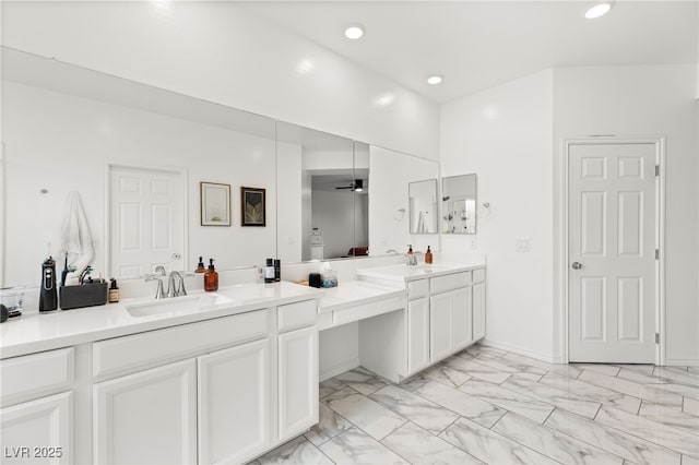 bathroom featuring ceiling fan and vanity