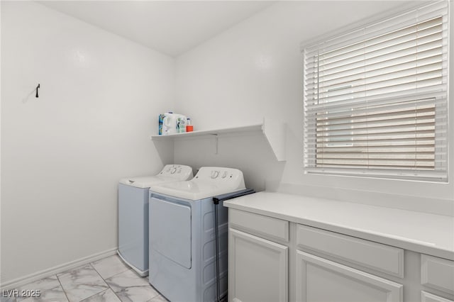 laundry room featuring cabinets and washing machine and dryer