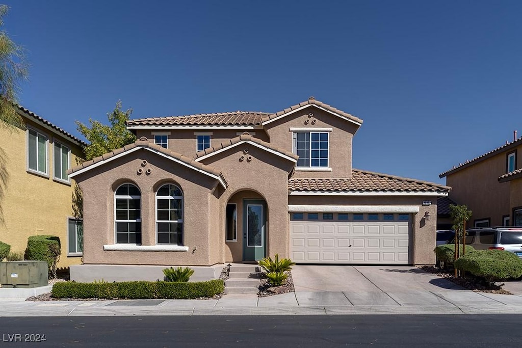 mediterranean / spanish-style home featuring a garage