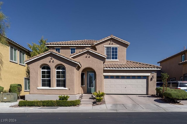 mediterranean / spanish-style home featuring a garage