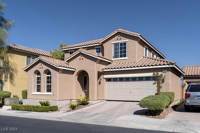 mediterranean / spanish house featuring a garage