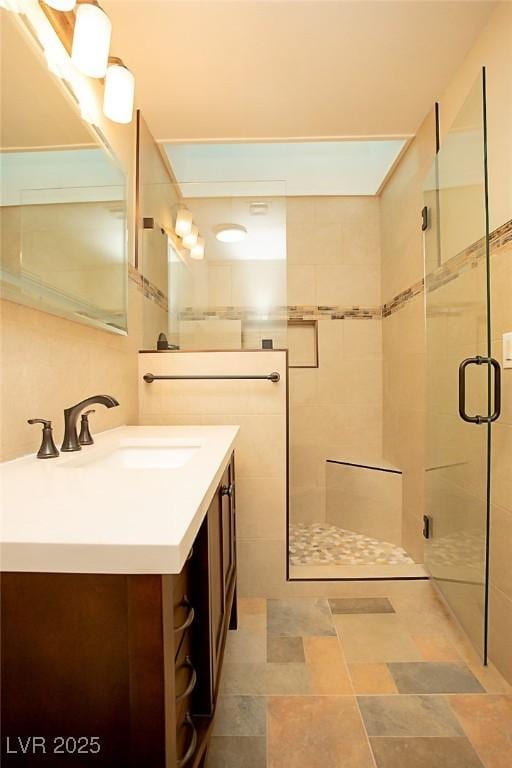 bathroom featuring vanity and an enclosed shower