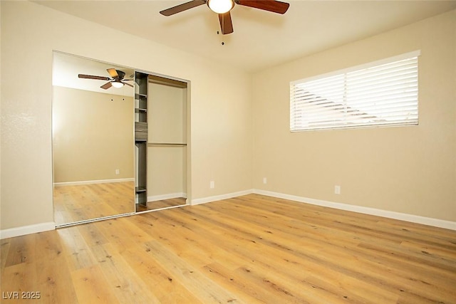 unfurnished bedroom featuring hardwood / wood-style floors, ceiling fan, and a closet