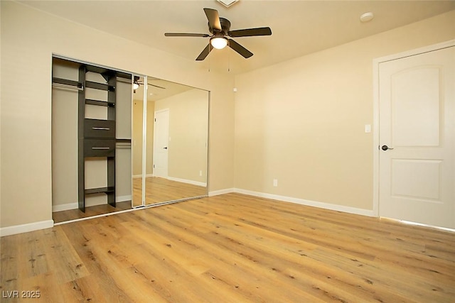 unfurnished bedroom with hardwood / wood-style flooring, ceiling fan, and a closet