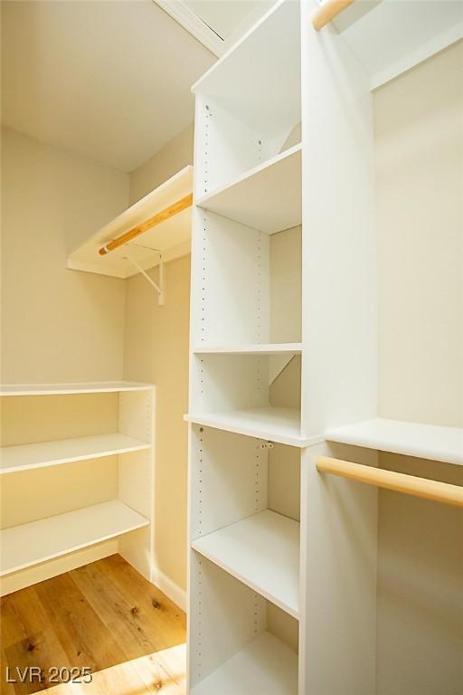 walk in closet featuring hardwood / wood-style flooring