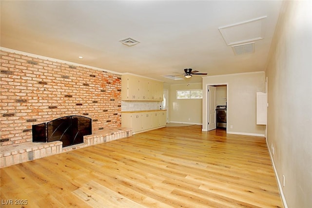 unfurnished living room featuring ceiling fan, ornamental molding, a fireplace, and light wood-type flooring