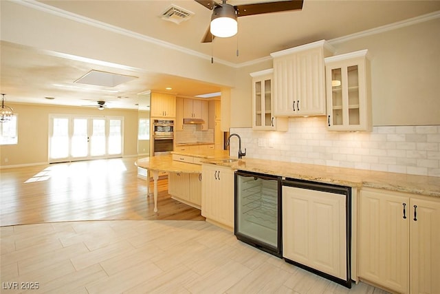 kitchen featuring crown molding, sink, wine cooler, and ceiling fan