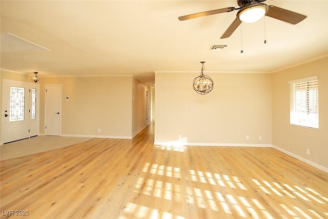 unfurnished living room featuring ornamental molding, ceiling fan with notable chandelier, and light hardwood / wood-style floors