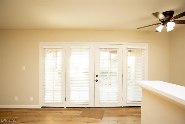 entryway featuring french doors, ceiling fan, and light hardwood / wood-style floors