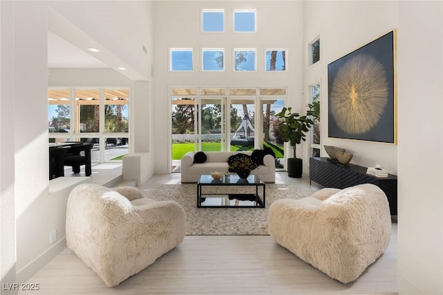 living room with french doors and a towering ceiling