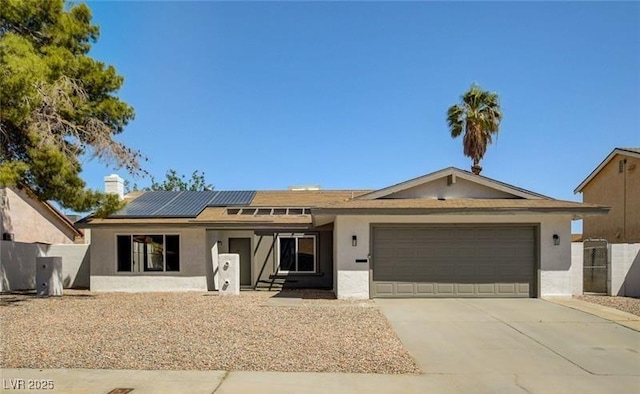 single story home featuring a garage and solar panels