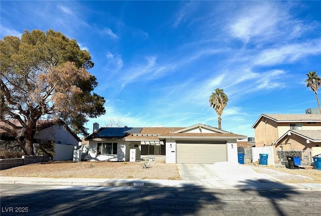 view of front of house with solar panels and a garage