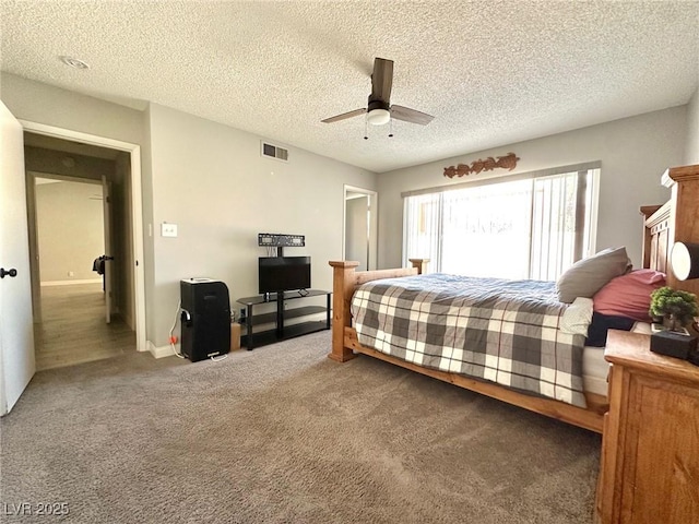 bedroom featuring carpet flooring, ceiling fan, and a textured ceiling