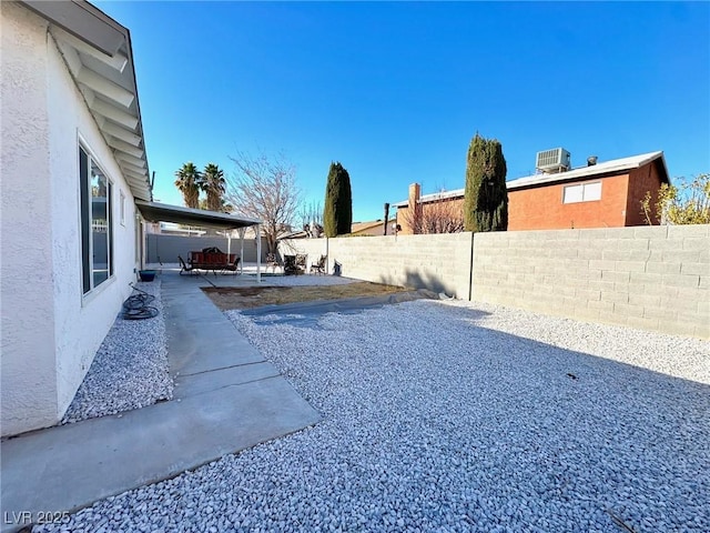 view of yard featuring a patio and central AC